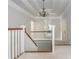 Upstairs hallway with tray ceiling featuring neutral color palette and access to multiple rooms at 1100 Lady Slipper Way, Canton, GA 30115
