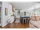 Bright kitchen featuring white cabinets, stainless steel appliances, and a blue island with bar stools at 1100 Lady Slipper Way, Canton, GA 30115