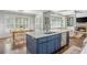 Bright kitchen with a blue island, stainless steel appliances, and an open view to the dining area at 1100 Lady Slipper Way, Canton, GA 30115