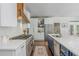 Modern kitchen with white countertops, stainless steel appliances, and a large gas range at 1100 Lady Slipper Way, Canton, GA 30115