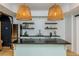 Bright kitchenette features a stainless-steel refrigerator, stylish floating shelves, and decorative pendant lighting at 1100 Lady Slipper Way, Canton, GA 30115