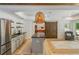 Bright kitchenette features a stainless-steel refrigerator, dark countertops, and an eye-catching island at 1100 Lady Slipper Way, Canton, GA 30115