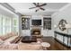 Spacious living room with built-in bookshelves, a fireplace, and a comfortable couch at 1100 Lady Slipper Way, Canton, GA 30115