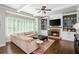 Inviting living room featuring custom built-ins, a fireplace, and hardwood floors at 1100 Lady Slipper Way, Canton, GA 30115