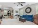 Spacious room with a large clock, a comfortable blue couch, and musical instruments for entertainment at 1100 Lady Slipper Way, Canton, GA 30115