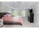 Spacious bedroom featuring a tray ceiling, chandelier, and lots of natural light from multiple windows at 1100 Lady Slipper Way, Canton, GA 30115
