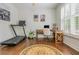 Home office with hardwood floors, natural light, a modern desk, and exercise equipment at 1100 Lady Slipper Way, Canton, GA 30115