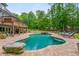 Resort-style pool and patio area, surrounded by lush landscaping and lounge seating at 1100 Lady Slipper Way, Canton, GA 30115