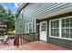 Exterior view of the deck and back door with a well-maintained lawn at 1320 Country Acres Ln, Lawrenceville, GA 30045