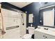 Modern bathroom featuring a glass shower, blue walls and a vanity with sink at 1320 Country Acres Ln, Lawrenceville, GA 30045