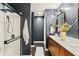 Modern bathroom featuring a glass shower, dark wood floors, and a vanity with double sinks at 1320 Country Acres Ln, Lawrenceville, GA 30045