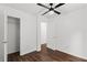 Cozy bedroom featuring wood floors, a ceiling fan, and closet, perfect for relaxation at 1320 Country Acres Ln, Lawrenceville, GA 30045