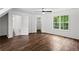 Bright bedroom with wood floors, a large window, and multiple closets at 1320 Country Acres Ln, Lawrenceville, GA 30045