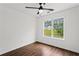 Cozy bedroom with hardwood floors and a window overlooking a lush yard at 1320 Country Acres Ln, Lawrenceville, GA 30045