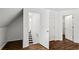 Bright bedroom showcasing three white doors and stylish wood floors at 1320 Country Acres Ln, Lawrenceville, GA 30045