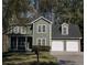 Two-story traditional home with a two-car garage and well-maintained landscaping at 1320 Country Acres Ln, Lawrenceville, GA 30045