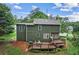 Two-story home with green siding, a shingled roof, and a spacious wooden deck at 1320 Country Acres Ln, Lawrenceville, GA 30045