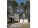 Two-story home featuring a two-car garage, traditional design, and a well-manicured lawn at 1320 Country Acres Ln, Lawrenceville, GA 30045