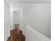 Hallway with hardwood floors and closet doors at 1320 Country Acres Ln, Lawrenceville, GA 30045