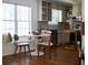Bright eat-in kitchen with wooden floors, modern table and chairs and large window at 1320 Country Acres Ln, Lawrenceville, GA 30045