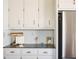 Modern kitchen featuring stainless steel appliances and white cabinets with elegant hardware at 1320 Country Acres Ln, Lawrenceville, GA 30045