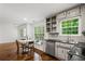 A spacious kitchen with white cabinets, stainless steel appliances, and an adjacent breakfast nook with a window at 1320 Country Acres Ln, Lawrenceville, GA 30045
