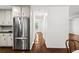 Spacious kitchen with stainless steel refrigerator and white cabinets at 1320 Country Acres Ln, Lawrenceville, GA 30045