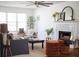 Cozy living room featuring a fireplace, neutral tones, and plenty of natural light at 1320 Country Acres Ln, Lawrenceville, GA 30045