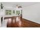 Open concept floor plan with hardwood floors, ceiling fan, and a fireplace at 1320 Country Acres Ln, Lawrenceville, GA 30045