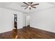 Light-filled main bedroom showcasing hardwood floors, a tray ceiling, and access to the bathroom at 1320 Country Acres Ln, Lawrenceville, GA 30045
