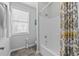 Well-lit bathroom featuring bathtub, shower, and a decorative shower curtain at 2100 Drew Nw Dr, Atlanta, GA 30318