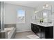 Bright bathroom with double vanity, a soaking tub and a large window for natural light at 2100 Drew Nw Dr, Atlanta, GA 30318