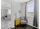 Bathroom sitting area featuring a gray armchair, side table, and a large window overlooking the exterior at 2100 Drew Nw Dr, Atlanta, GA 30318