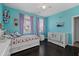 Vibrant bedroom with two beds, blue walls, and plenty of natural light at 2100 Drew Nw Dr, Atlanta, GA 30318