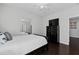 Cozy bedroom featuring dark wood floors, ceiling fan, and mirrored closet at 2100 Drew Nw Dr, Atlanta, GA 30318