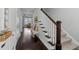 Inviting entryway with dark wood floors, staircase, and a glimpse of a bright, airy living space at 2100 Drew Nw Dr, Atlanta, GA 30318