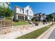 Inviting two-story home features a charming porch, stone retaining wall and well-kept landscaping at 2100 Drew Nw Dr, Atlanta, GA 30318