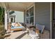Relax on this charming porch swing and chairs with floral arrangements and inviting cushions at 2100 Drew Nw Dr, Atlanta, GA 30318
