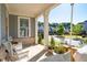 Relax on this charming front porch swing and chairs with floral arrangements at 2100 Drew Nw Dr, Atlanta, GA 30318