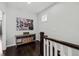 Upstairs hallway featuring dark hardwood floors, neutral walls, and a decorative console table at 2100 Drew Nw Dr, Atlanta, GA 30318