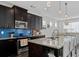 Spacious kitchen with a large island, granite countertops, stainless steel appliances, and a blue backsplash at 2100 Drew Nw Dr, Atlanta, GA 30318