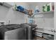 Well-organized laundry room with modern washer and dryer, shelving, and storage baskets at 2100 Drew Nw Dr, Atlanta, GA 30318