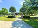 Inviting park entrance featuring the Heman E. Perry Park sign, stone pillars, and lush greenery surrounding at 2100 Drew Nw Dr, Atlanta, GA 30318