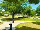 Scenic view of a well-maintained park with a playground, stage, open green spaces, and walking paths at 2100 Drew Nw Dr, Atlanta, GA 30318