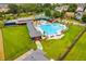 Aerial view of community pool area with large pool, covered seating, lounge chairs, and expansive green space at 2100 Drew Nw Dr, Atlanta, GA 30318
