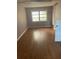 Interior view of an empty room with hardwood flooring and natural light at 2526 Panola Rd, Lithonia, GA 30058