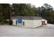 Commercial building featuring metal siding, asphalt parking, and awning at 2526 Panola Rd, Lithonia, GA 30058