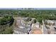 Aerial view of a modern townhome community surrounded by lush greenery and city skyline at 339 Skylar Se Way, Atlanta, GA 30315