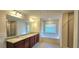 Bathroom featuring double sinks, a soaking tub, and a glass-enclosed shower at 5010 Lynnonhall Ct, Stonecrest, GA 30038