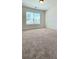 Bright bedroom featuring a large window and neutral carpet at 5010 Lynnonhall Ct, Stonecrest, GA 30038